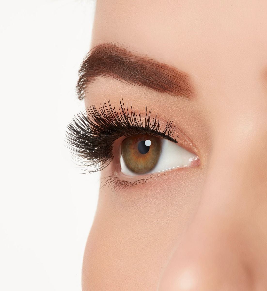: A model with one eye open wearing Ardell Aqua Lashes 340 upper false lashes to show how they look on the eye